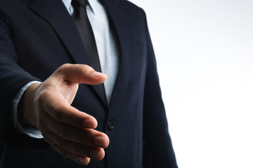 Business man with right hand reaching out for shake hands
