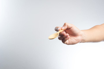 Man hand holding a wooden spoon