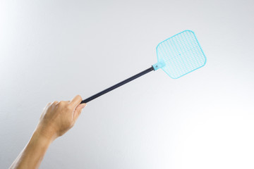 hand holding fly or insect swatter