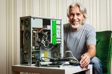 Senior Man Assembling A Desktop Computer