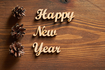 Happy New Year!/Happy New Year! - A phrase with wooden letters on a wooden backg