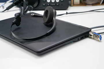 Fototapeta na wymiar black headset on laptop computer