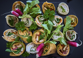 A collection of cut wraps with radish and leafy salads