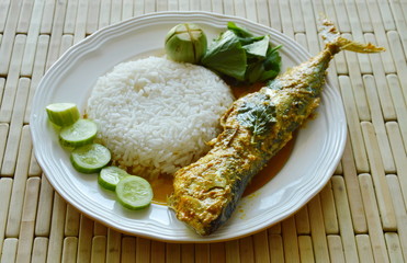 boiled mackerel in spicy turmeric sauce eat couple with rice and vegetable