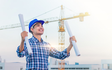 Portrait of engineer wear a blue safety helmet and hold the blue