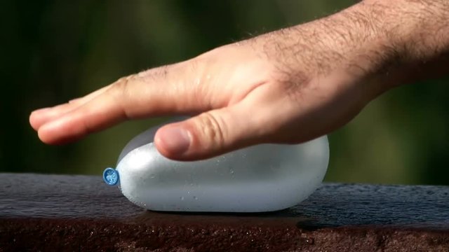 Blue Water Balloon Exploding When Smashed By Hand Super Slow Motion