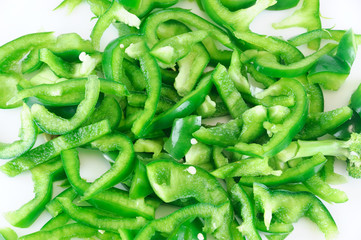 fresh chopped green pepper for salad isolated on white background