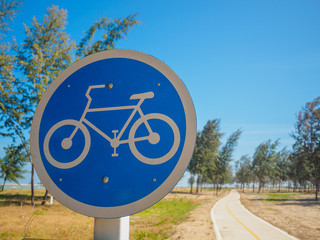 bicycle sign and symbol with bicycle lane on beach side with blue sky