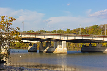 Theodore Roosevelt Memorial bridge in autumn, Washington DC. Potomac River provides opportunity for relaxation and recreation in urban settings.