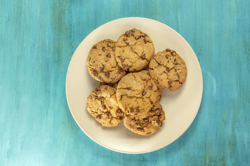 Plate of freshly baked chocolate chips cookies, with copyspace