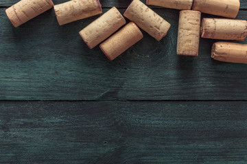 Wine corks on dark wooden texture with copyspace