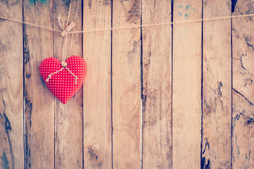 Heart fabric hanging on clothesline and wood background with spa