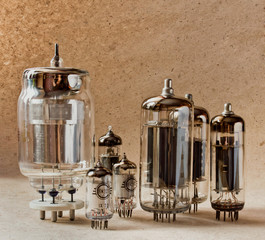 different electronic vacuum tubes on kraft paper background in warm colours.