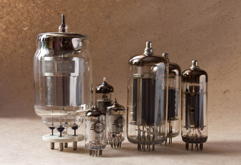 electronic vacuum tubes on kraft paper background in warm colours.