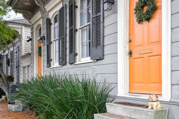 New Orleans quaint houses with gingerbread trim and orange doors