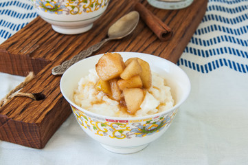 Rice porridge with milk in a small bowls on a table. Breakfast concept.