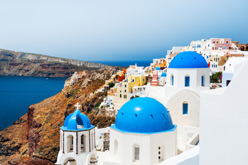 White church with blue domes on Santorini island, Greece