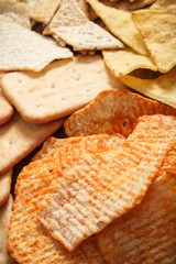 Heap of salted crisps and cookies, concept of unhealthy food