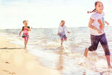 kids running at the beach, runners have motion blur