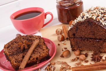 Dark cake with chocolate, cocoa and plum jam, cup of coffee, delicious dessert