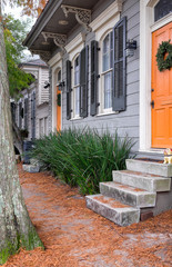 New Orleans quaint shotgun houses with gingerbread trim. Vertical