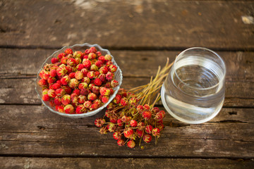 Mineral water in  crystal glass on  table and strawberries