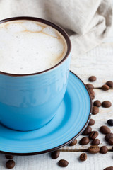 cappuccino, coffee beans and towel