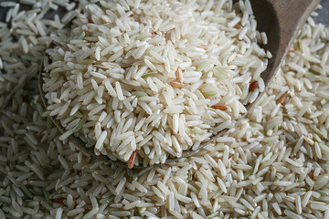 Brown rice, jasmine rice on the wood background