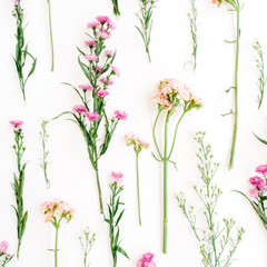 Floral pattern with pink and beige wildflowers, green leaves, branches on white background. Flat lay, top view. Valentine's background