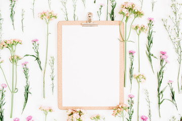Clipboard mockup and wildflowers pattern. Flat lay, top view