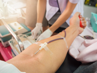 Obraz na płótnie Canvas Nurse receiving blood from blood donor in hospital.
