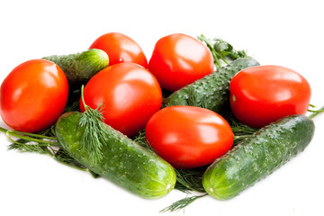 Red tomatoes and green cucumbers for salad. Isolated on white background.
