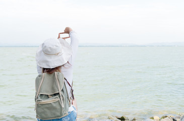 Hipster young woman show finger frame for take picture dam