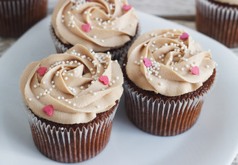Chocolate cupcakes decorated with cream rose  hearts
