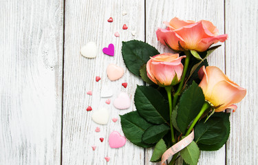 Pink roses on a wooden background