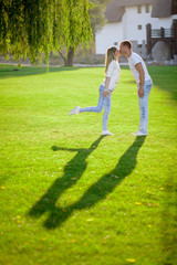 the shadow of a young couple on the grass