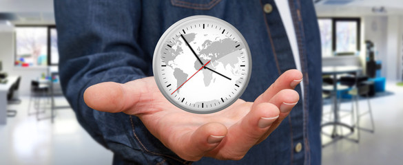 Businessman holding a clock in his hand