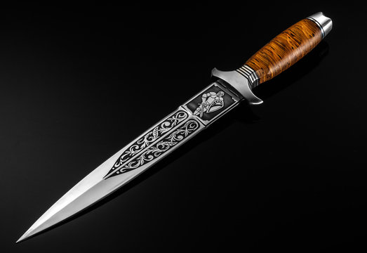 Hunting Knife On A Black Background.