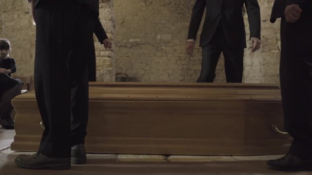 Pallbearers leaving church with coffin