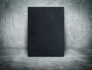 Blank black canvas frame at grunge concrete room,Mock up templat