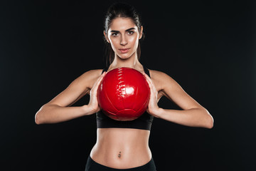 Portrait of a beautiful sports woman holding fitness ball