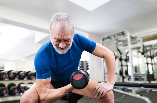 Senior Man In Gym Working Out With Weights.