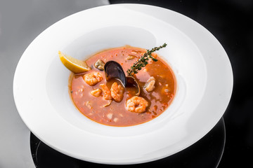 French Bouillabaisse fish soup with seafood, salmon fillet, shrimp, rich taste, tasty dinner