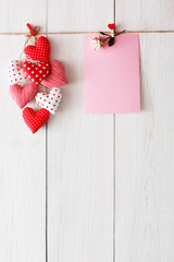 Valentine day background, pillow hearts and card on wood