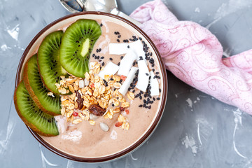 Chocolate smoothie bowl with kiwi and granola. Love for a healthy raw food concept.