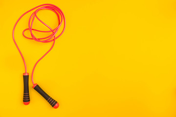 Top view of Skipping rope on yellow background