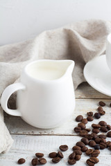 coffee beans, cup and milk jug