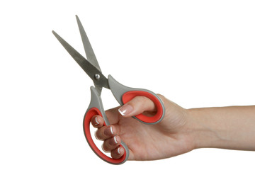 A female hand holding a large scissors isolated on a white background.