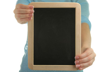 A woman is holding a black board for inscriptions isolated on a white background.
