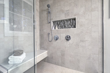 Glass walk-in shower in a bathroom of brand new home